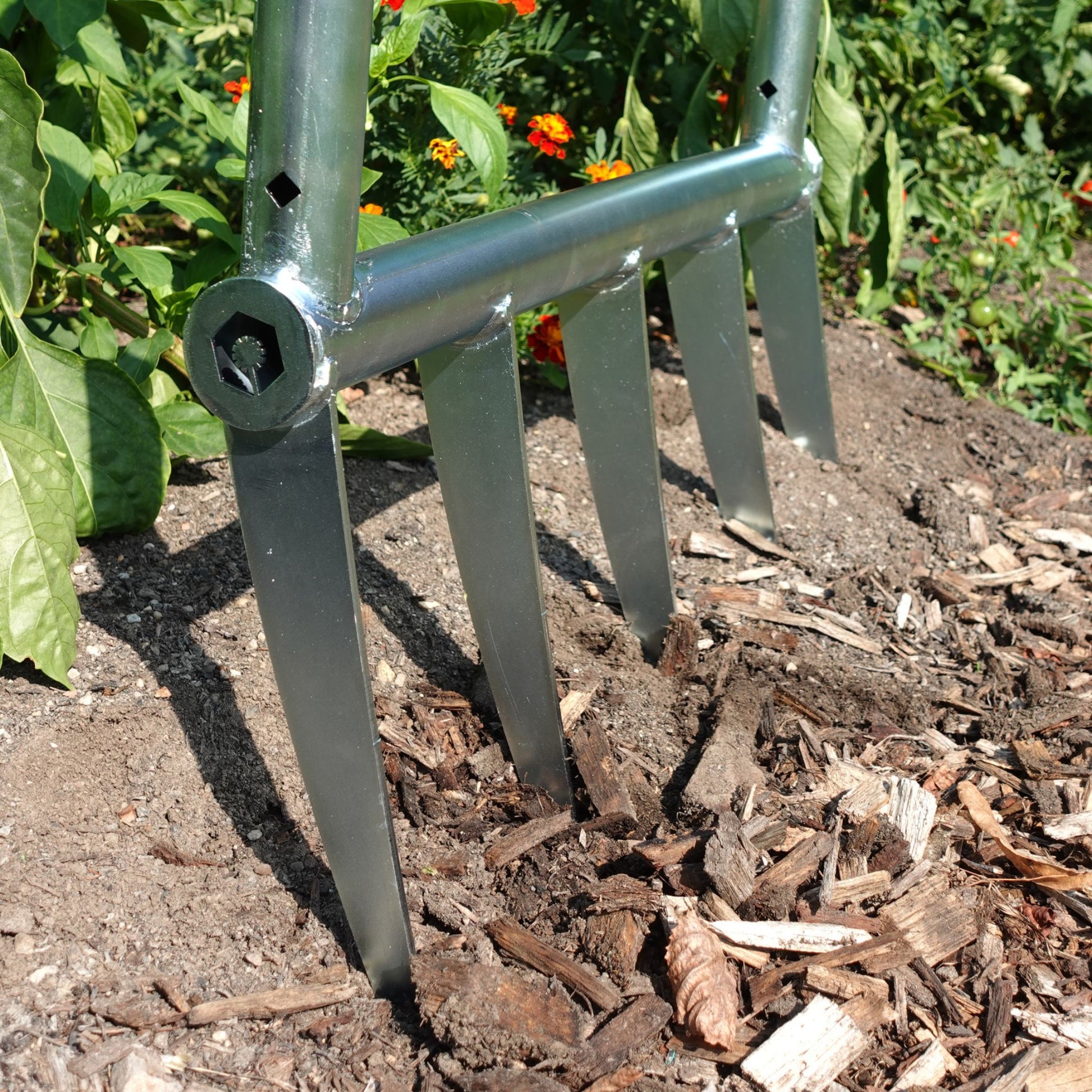 Side view of Green Tools Tech broadfork highlighting solid steel frame