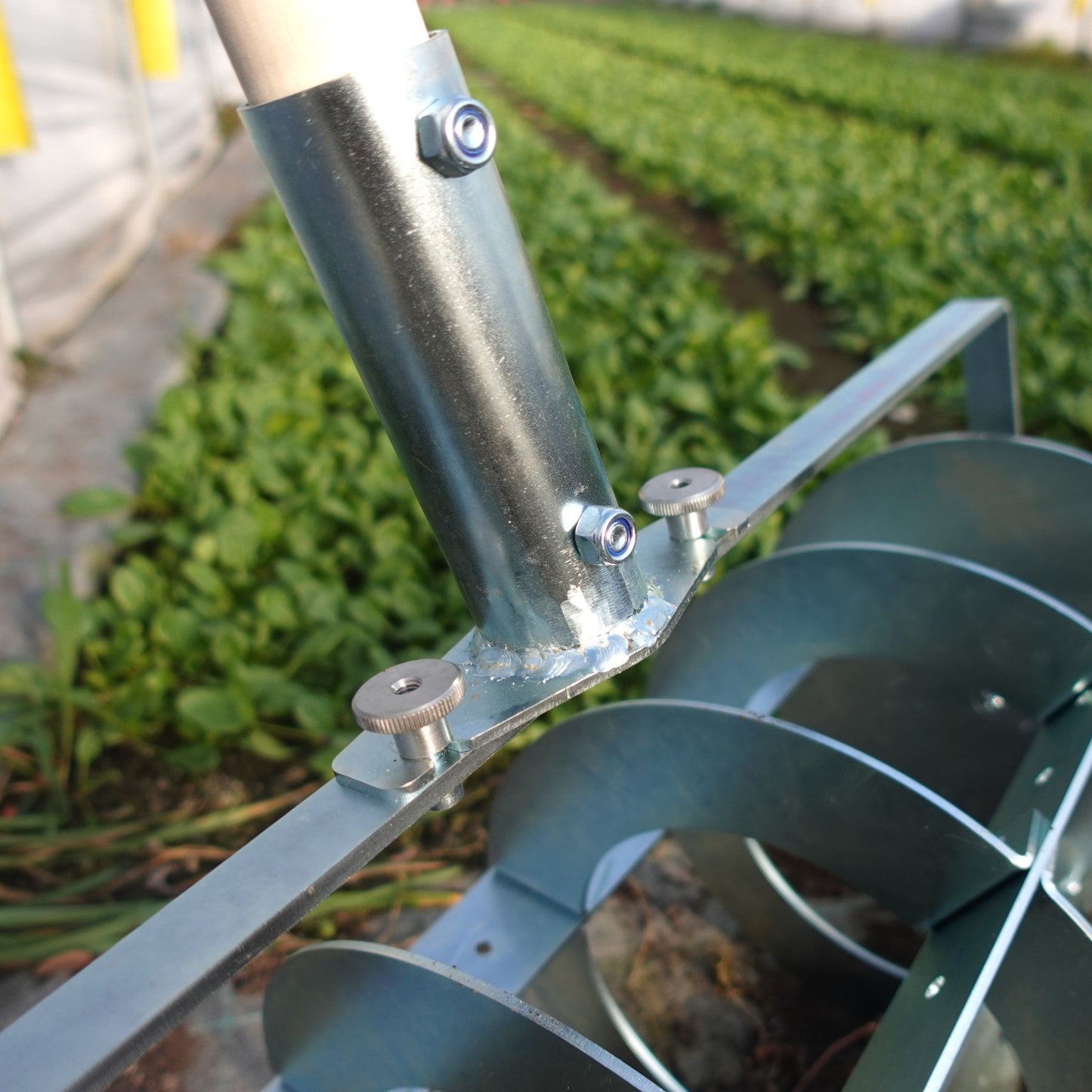 A close up of a Green Tools Tech Grid Marker VAR20 with adjustable steel discs for precise no-dig market garden bed layout