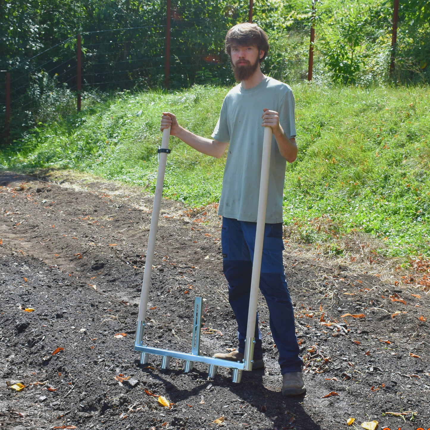 Person using Green Tools Tech Multi Dibbler with adjustable dibbles and row marker for fast no-dig market garden transplanting on 75 cm beds