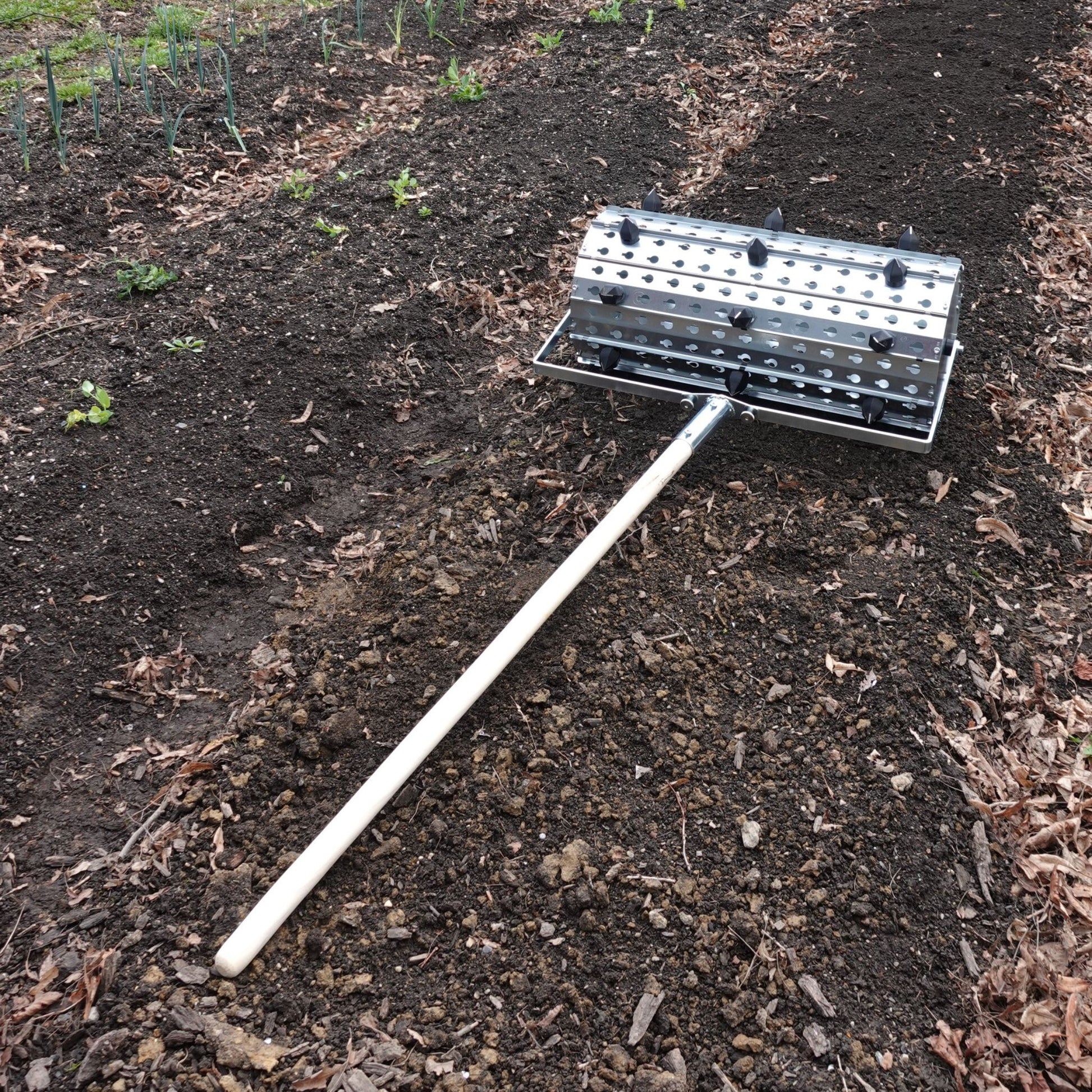 Green Tools Tech Rolling Dibbler used for precise no-dig market garden transplanting and cover crop crimping on biointensive beds