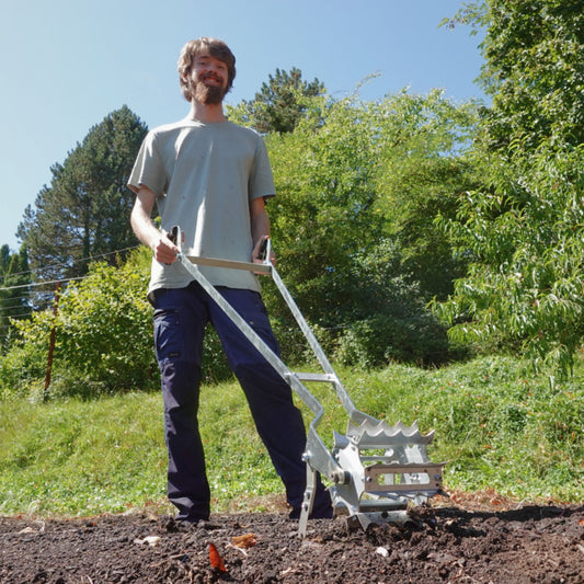 Person using Green Tools Tech Roto Hoe to cultivate and weed a market garden bed