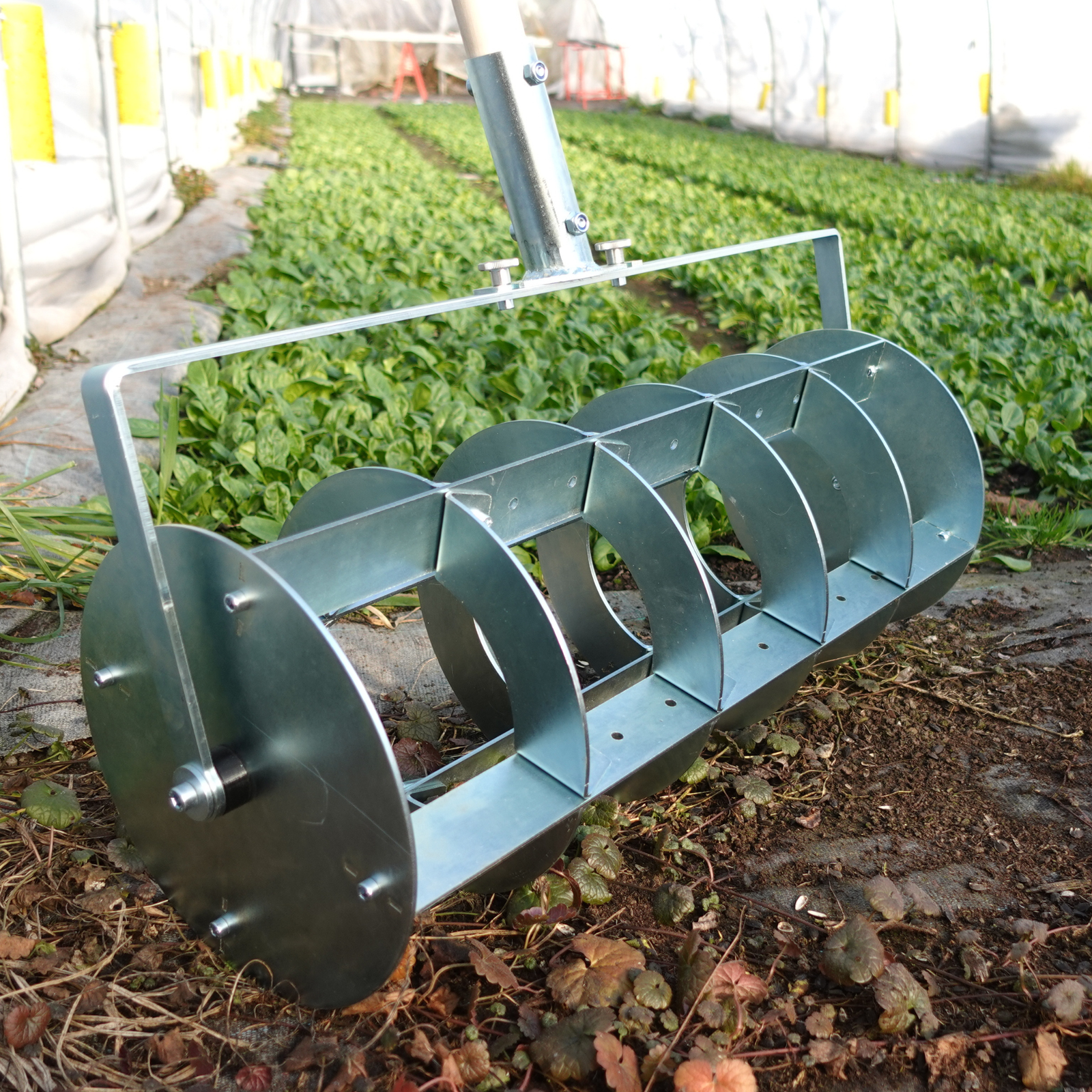 A Grid Marker being used for laying out a precise planting grid on a no-dig market garden bed.
