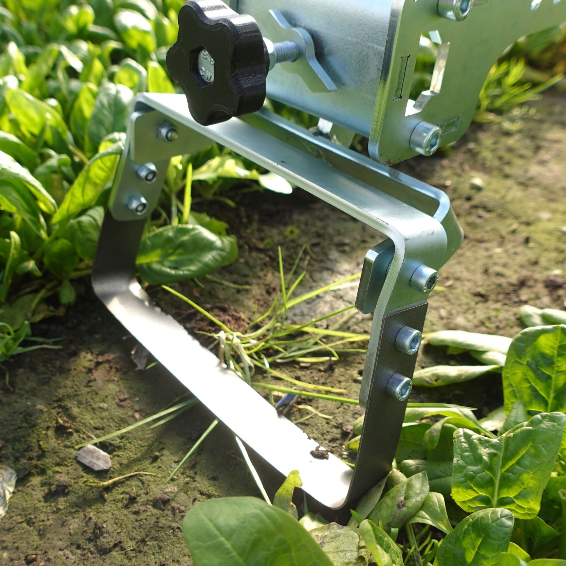 A close up of the Green Tools Tech Single Wheel Hoe 20 cm swing hoe blade for efficient no-dig market garden weeding and soil cultivation