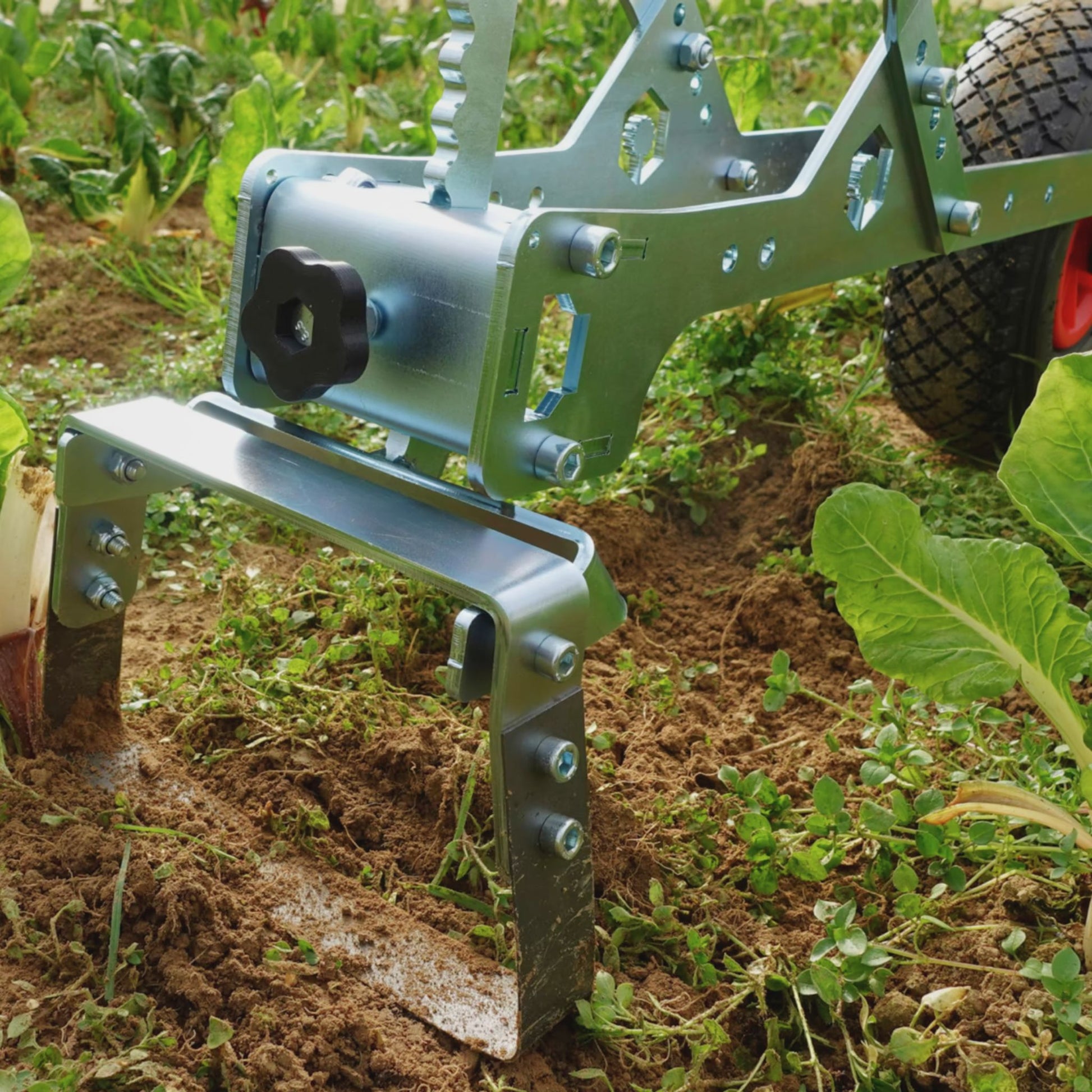 A close up of the Green Tools Tech Single Wheel Hoe 20 cm swing hoe blade for efficient no-dig market garden weeding and soil cultivation