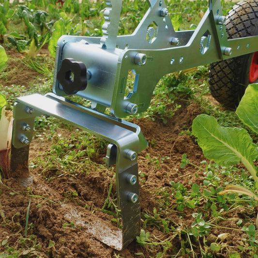 A close up of the Green Tools Tech Single Wheel Hoe 20 cm swing hoe blade for efficient no-dig market garden weeding and soil cultivation