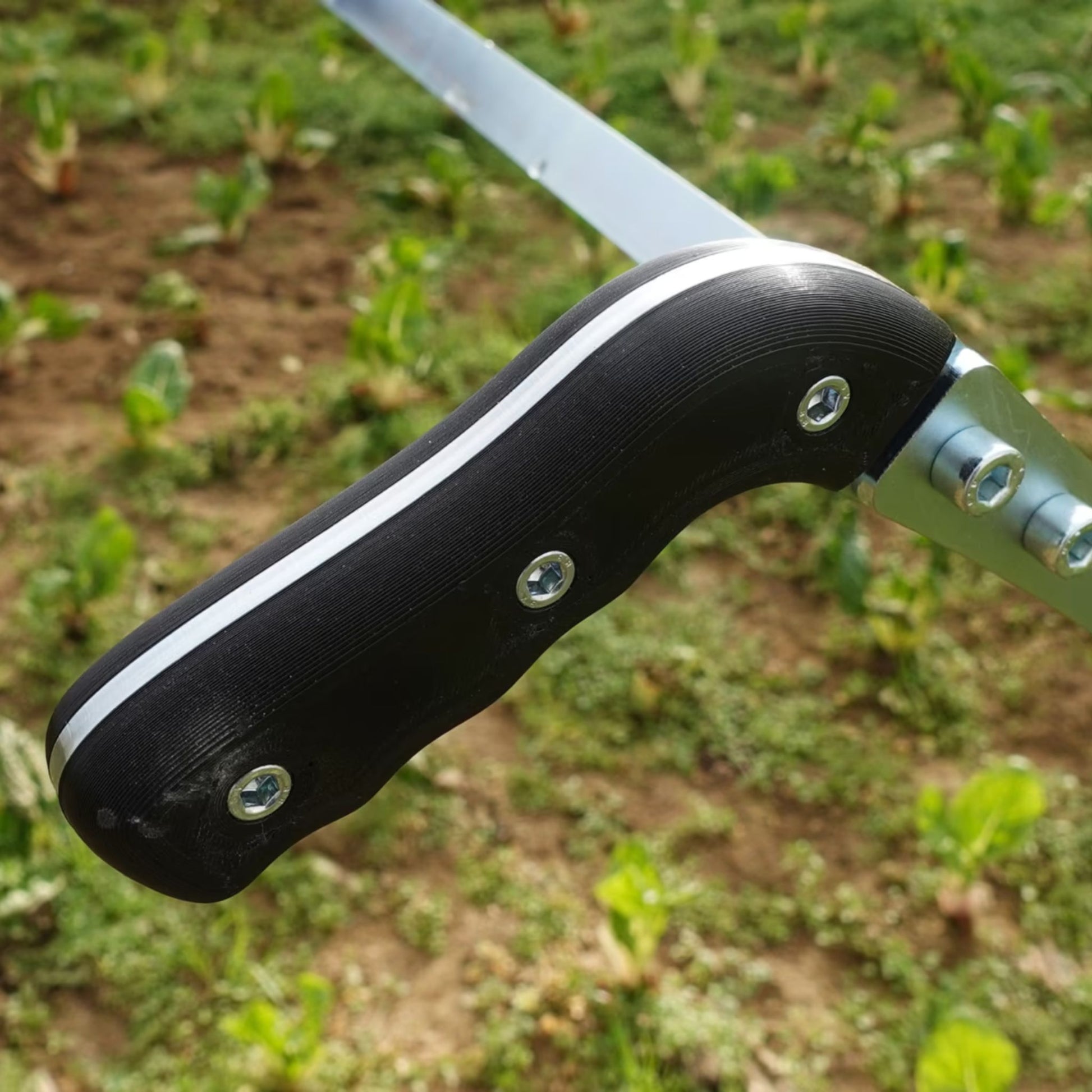 A close up of the Green Tools Tech Single Wheel Hoe handles for efficient no-dig market garden weeding and soil cultivation