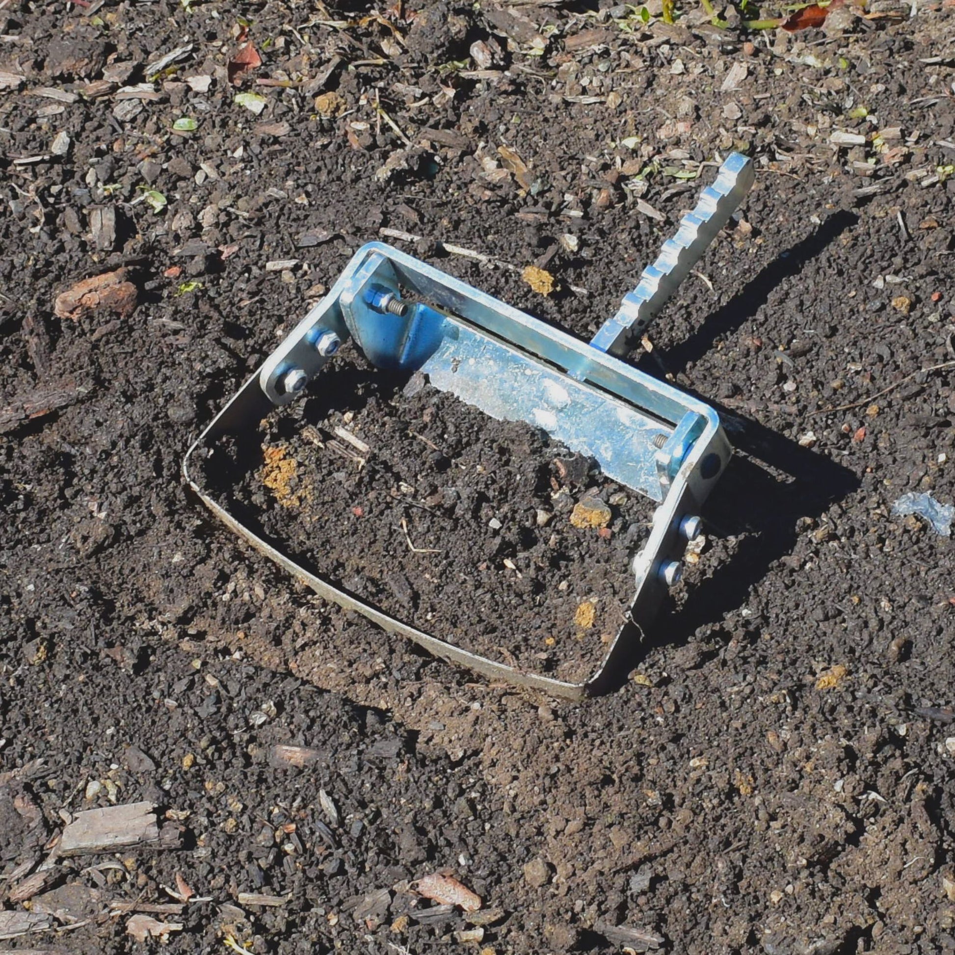 A close up of the Green Tools TECH Single Wheel Hoe 20 cm swing hoe blade for efficient no-dig market garden weeding and soil cultivation