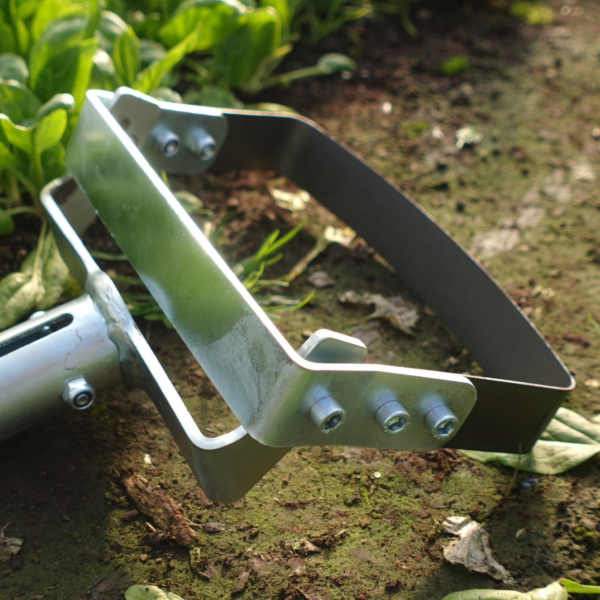 A close up of a Green Tools Tech Swing Hoe 20 with spring steel blade for fast no-dig market garden weeding and soil loosening between crops