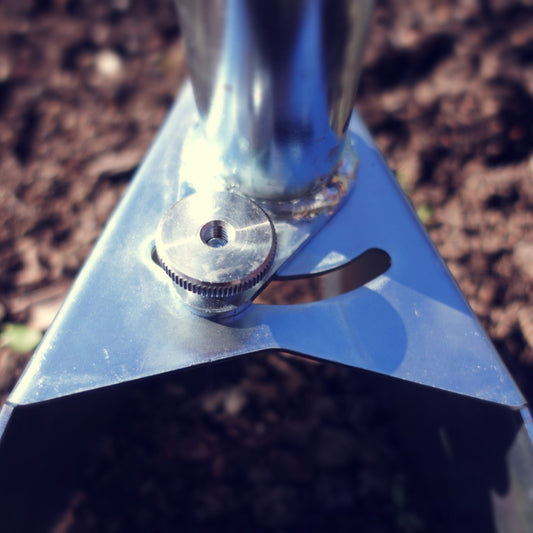 A close up of the Zip Plow creating precise furrows in no-dig market garden beds for paperpots, plugs, and onion transplants